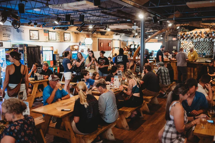 One Well Brewing transforms Kalamazoo craft beer with innovative brews, 56+ pinball machines, and community-first philosophy. From living room to landmark.