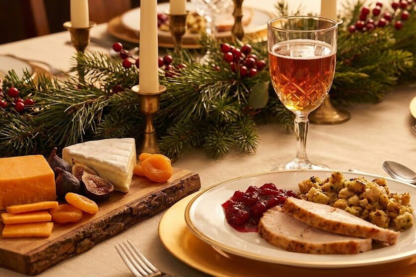 Christmas ale paired with roasted turkey dinner and winter ale next to aged cheese board for holiday entertaining