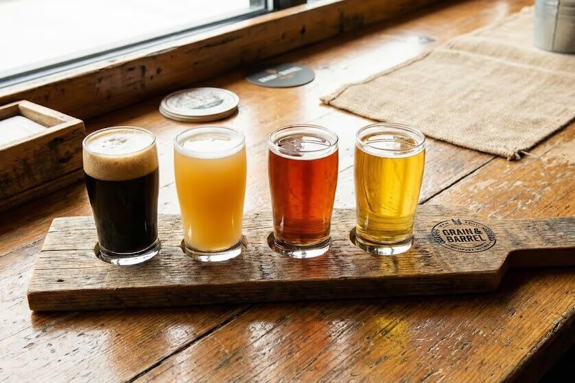 Craft beer flight showing contrast between dark pastry stout and clear golden lager on wooden tasting board