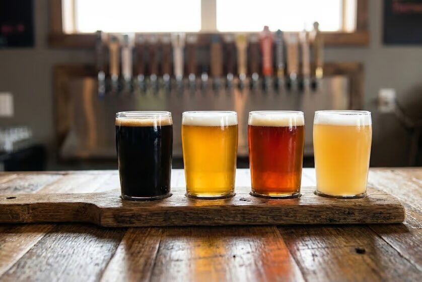 Craft beer tasting flight with multiple beer samples including imperial stouts, IPAs, and winter warmers at Iowa beer festival